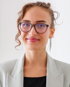 Photo of Lara-Marie Sattler looking at the camera and smiling.